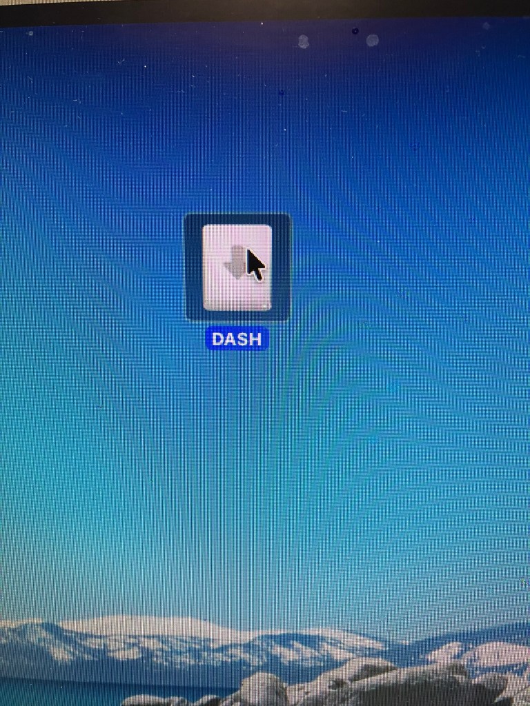 A desktop icon labeled 'DASH' with a downward arrow, set against a blue background that resembles a mountain landscape.