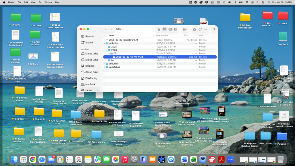A computer desktop showing various folders and files organized on a scenic background of blue water and mountains. A Finder window is open, displaying recent files and folders with a focus on a specific file and its details.